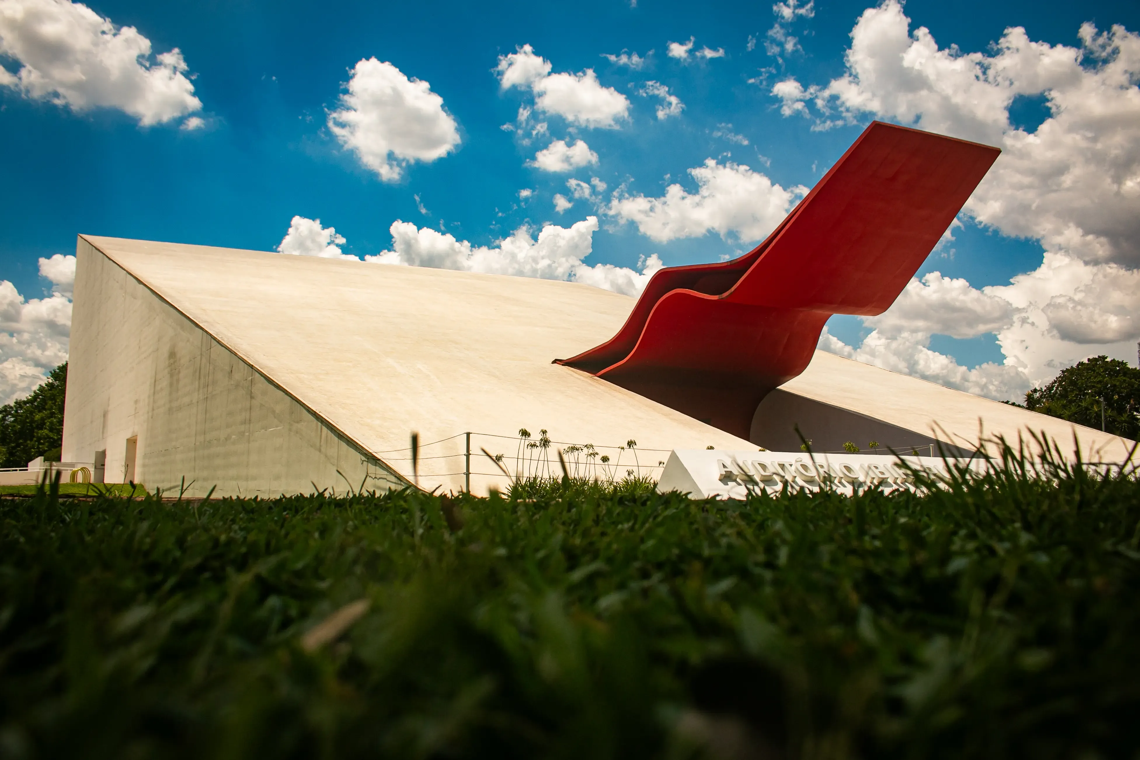 View of Ibirapuera Auditorium with its red marquee and a blue sky
