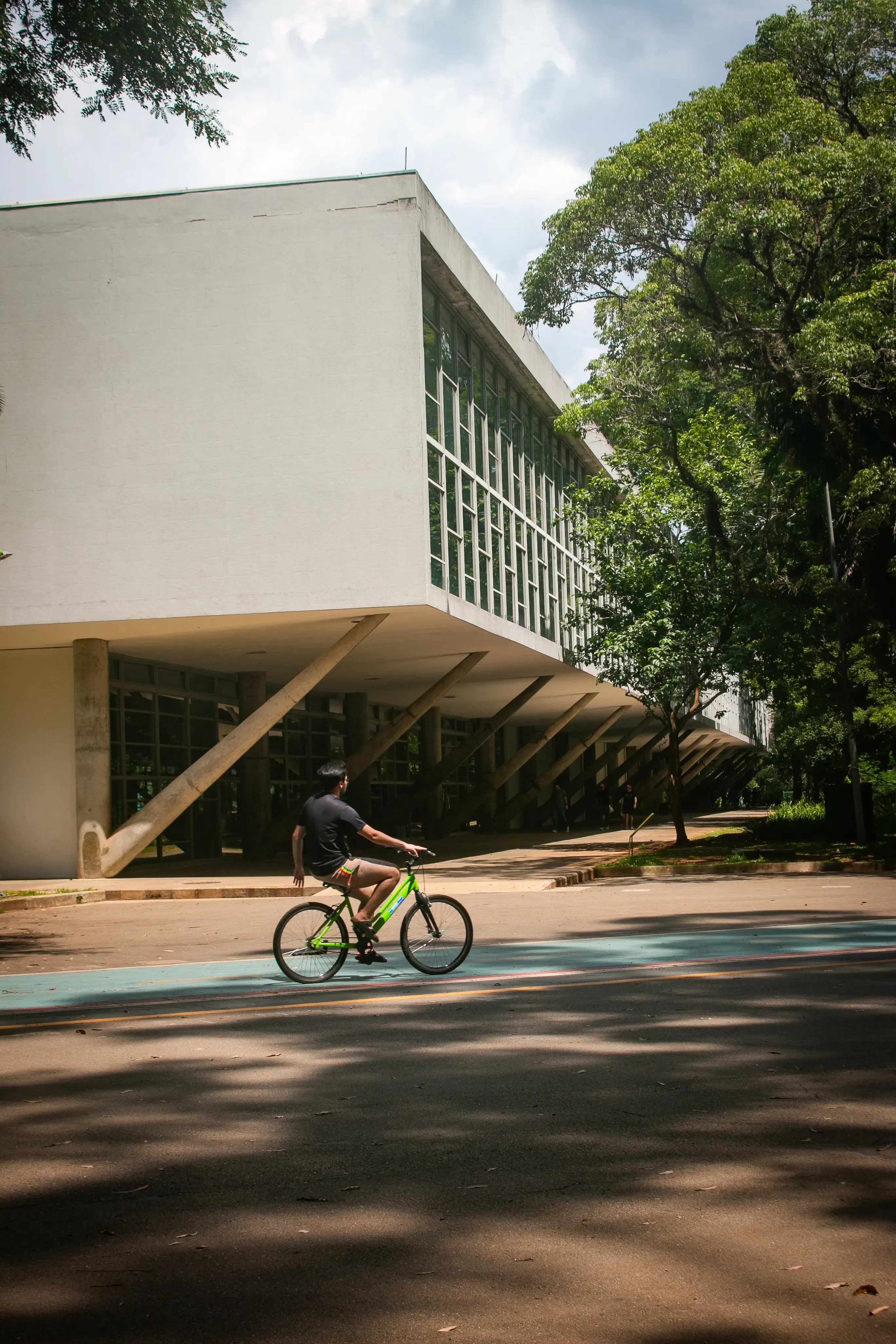 Cyclist passing in front of the Bienal Pavilion in Ibirapuera Park