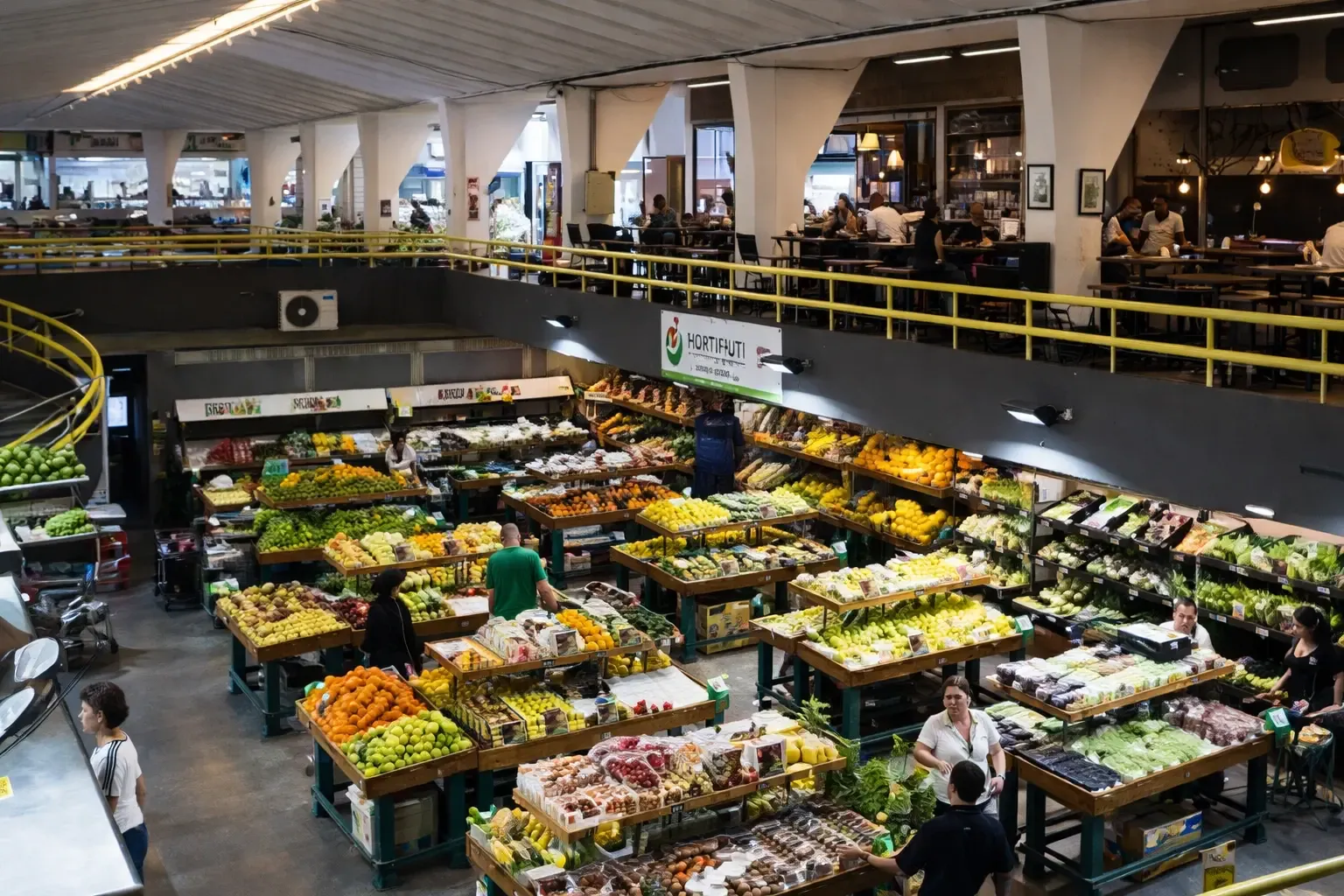 Busy indoor produce market with colorful fruit and vegetable stands