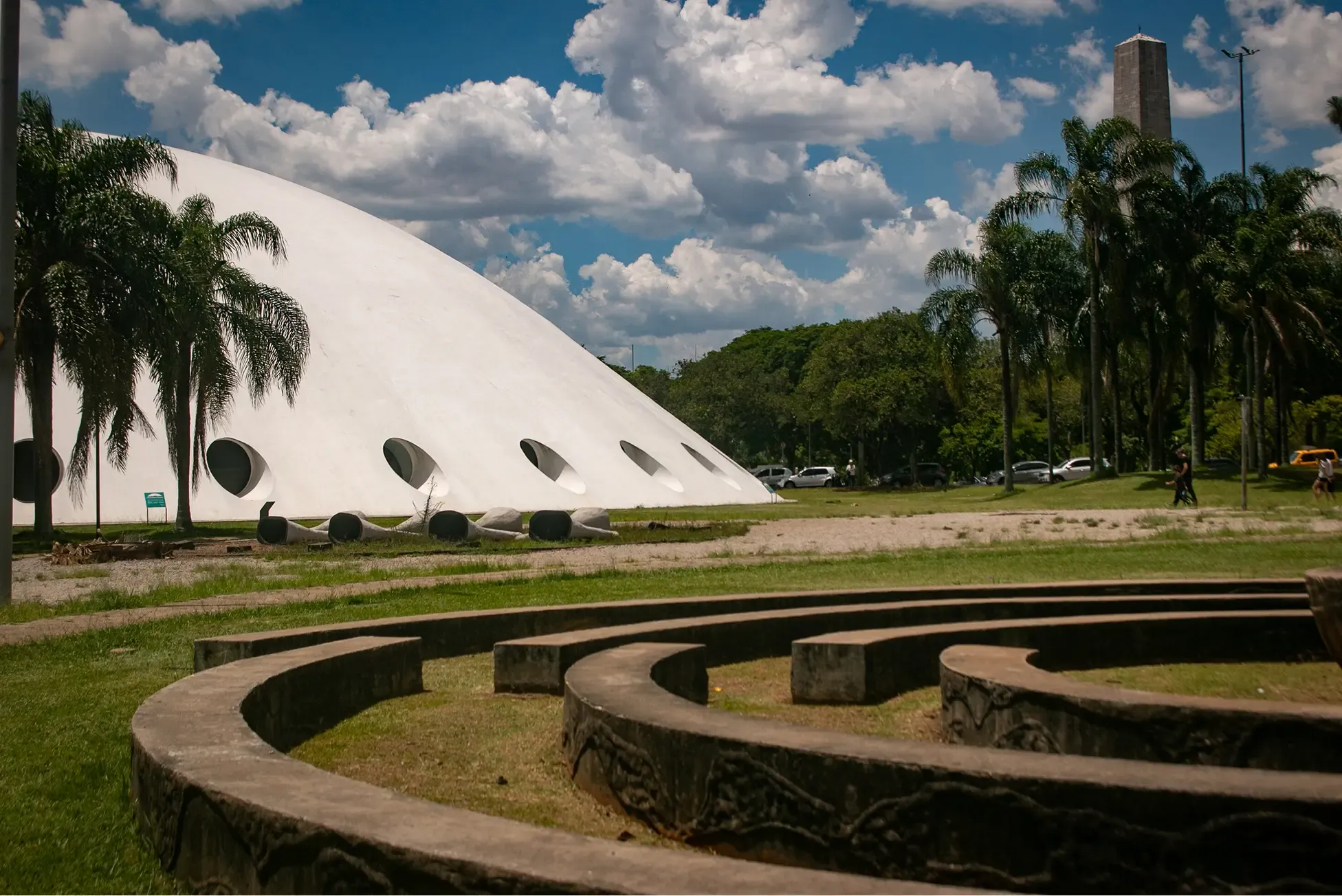 White dome building with circular windows and palm trees