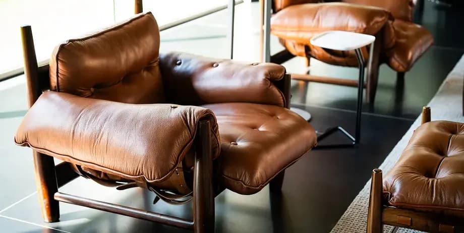 Mid-century leather lounge chair with tufted cushions in a sunlit modern interior