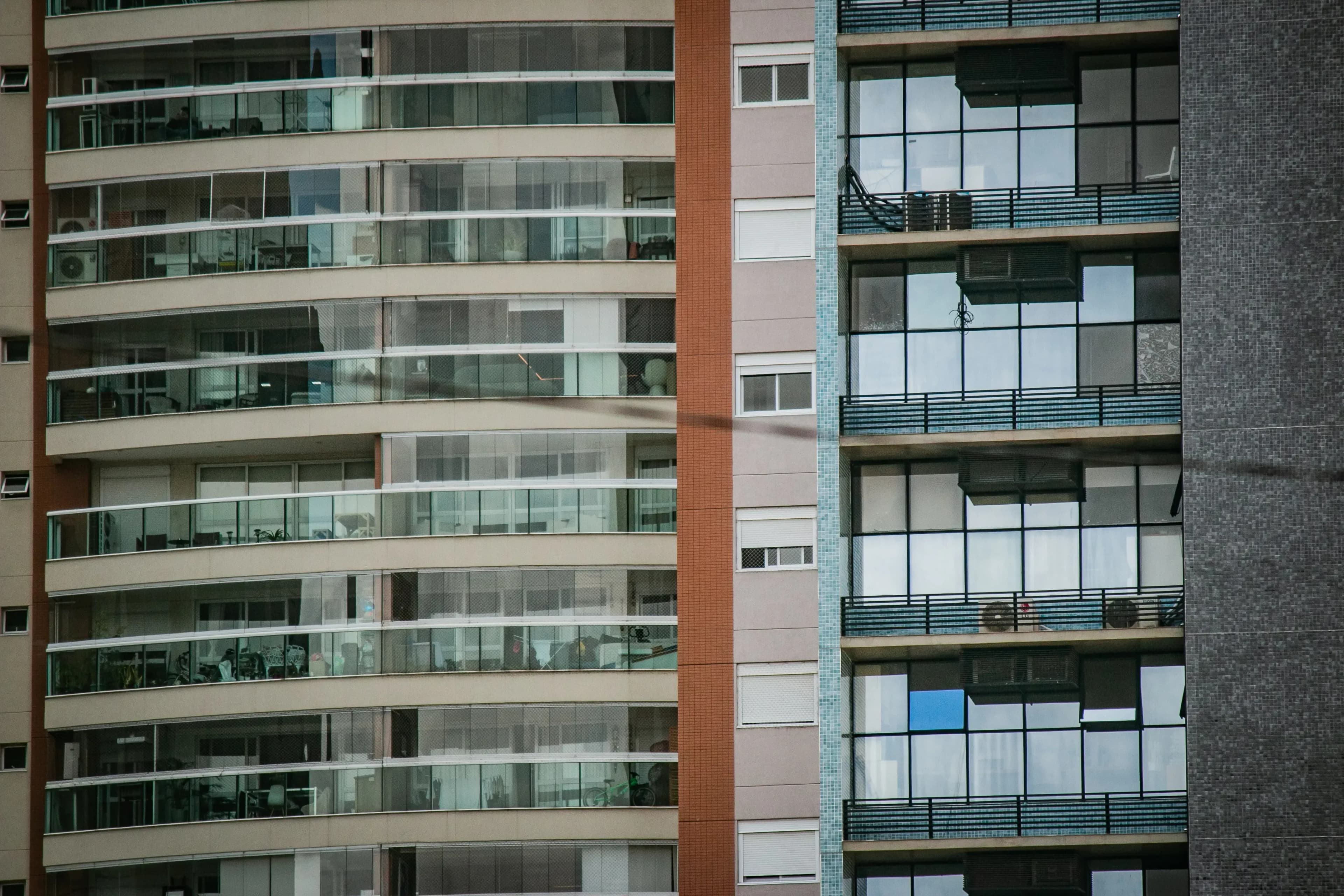 Close-up of apartment building balconies and windows in a dense urban block